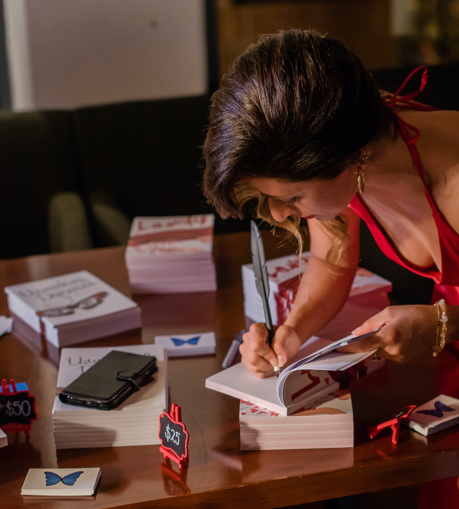 Anna Krjatian signing a book at the Lovely book launch event in Sydney Harbour.